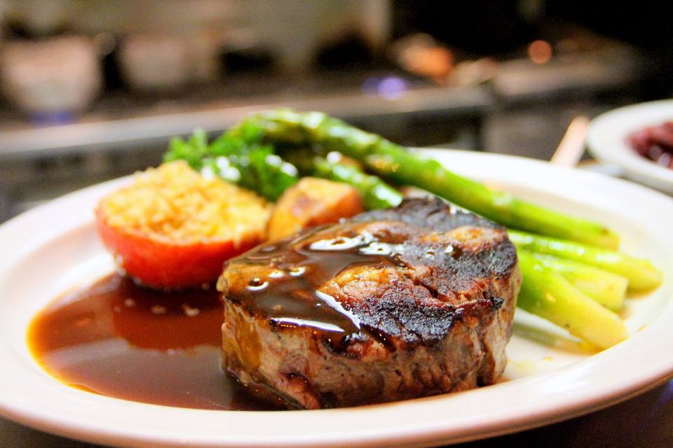 A plated steak with asparagus and dauphinoise