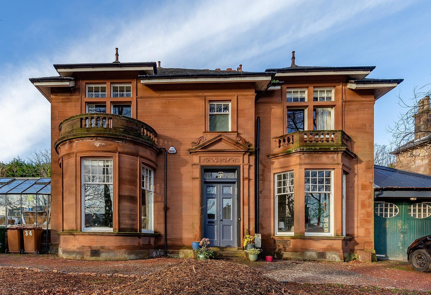 A red sandstone villa with bay windows